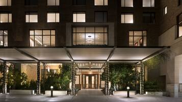 Hotel features a modern design with evenly spaced windows and a covered entrance area.