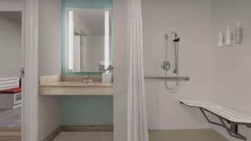 A modern bathroom with a shower, a sink, and a bench.