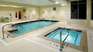 An indoor swimming pool with clear lane markings, a lifeguard chair, and a sign indicating a depth of 3 feet 9 inches. - Hilton Garden Inn Cleveland East/Mayfield Village (Mayfield)