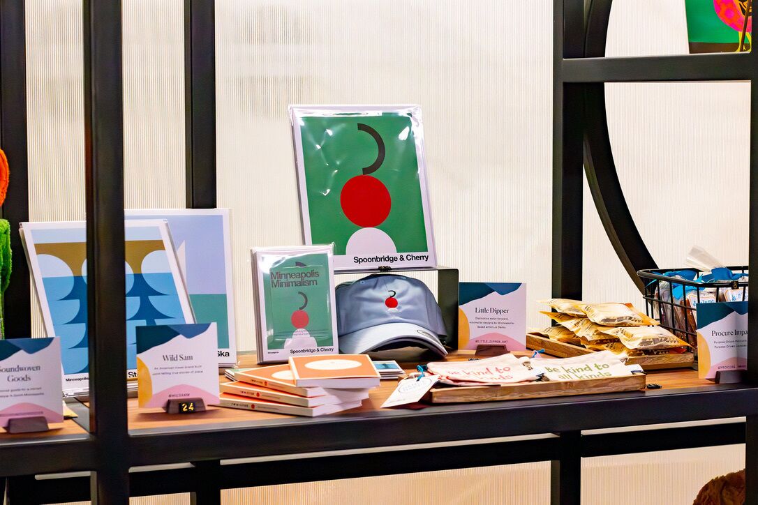 A display of books and promotional materials on a table, including titles like "Spoonbridge & Cherry" and "Wild Sam."