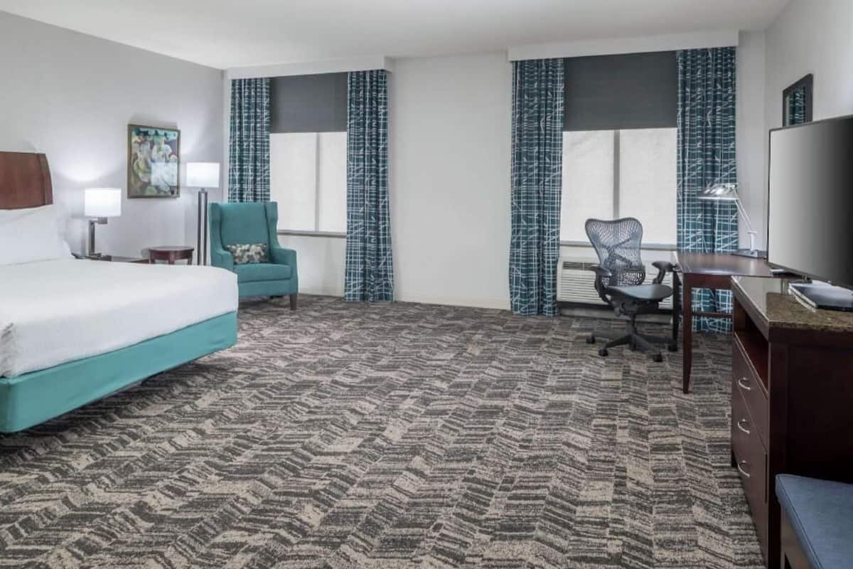 Premium bedding, desk, laptop workspace, blackout drapes
