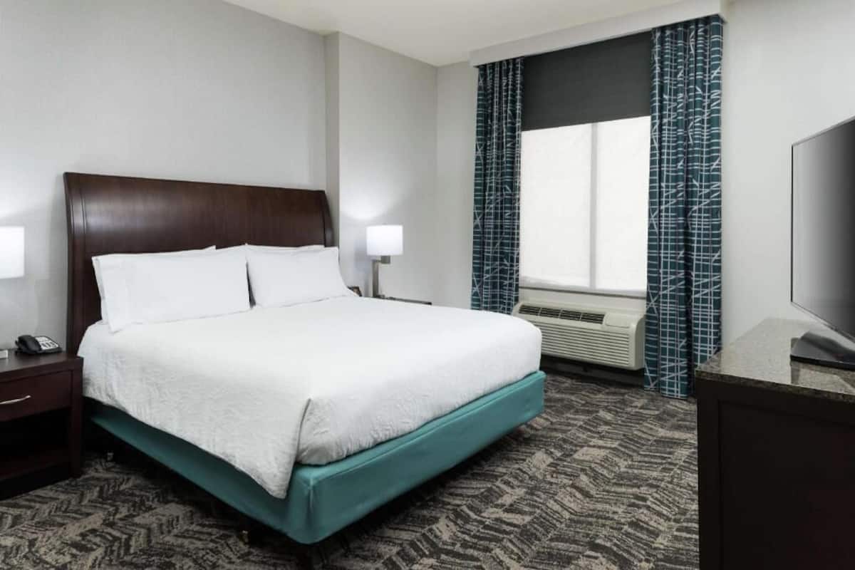 Premium bedding, desk, laptop workspace, blackout drapes