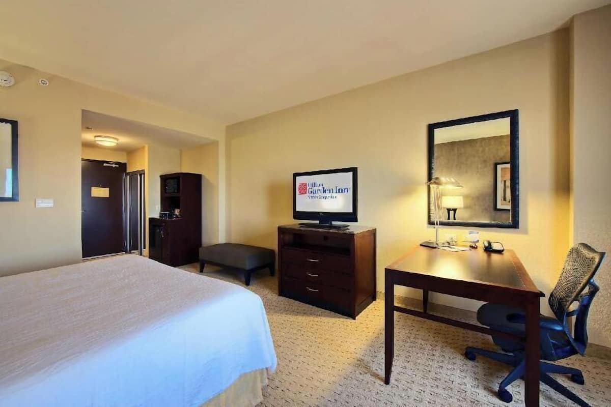 Premium bedding, desk, laptop workspace, blackout drapes