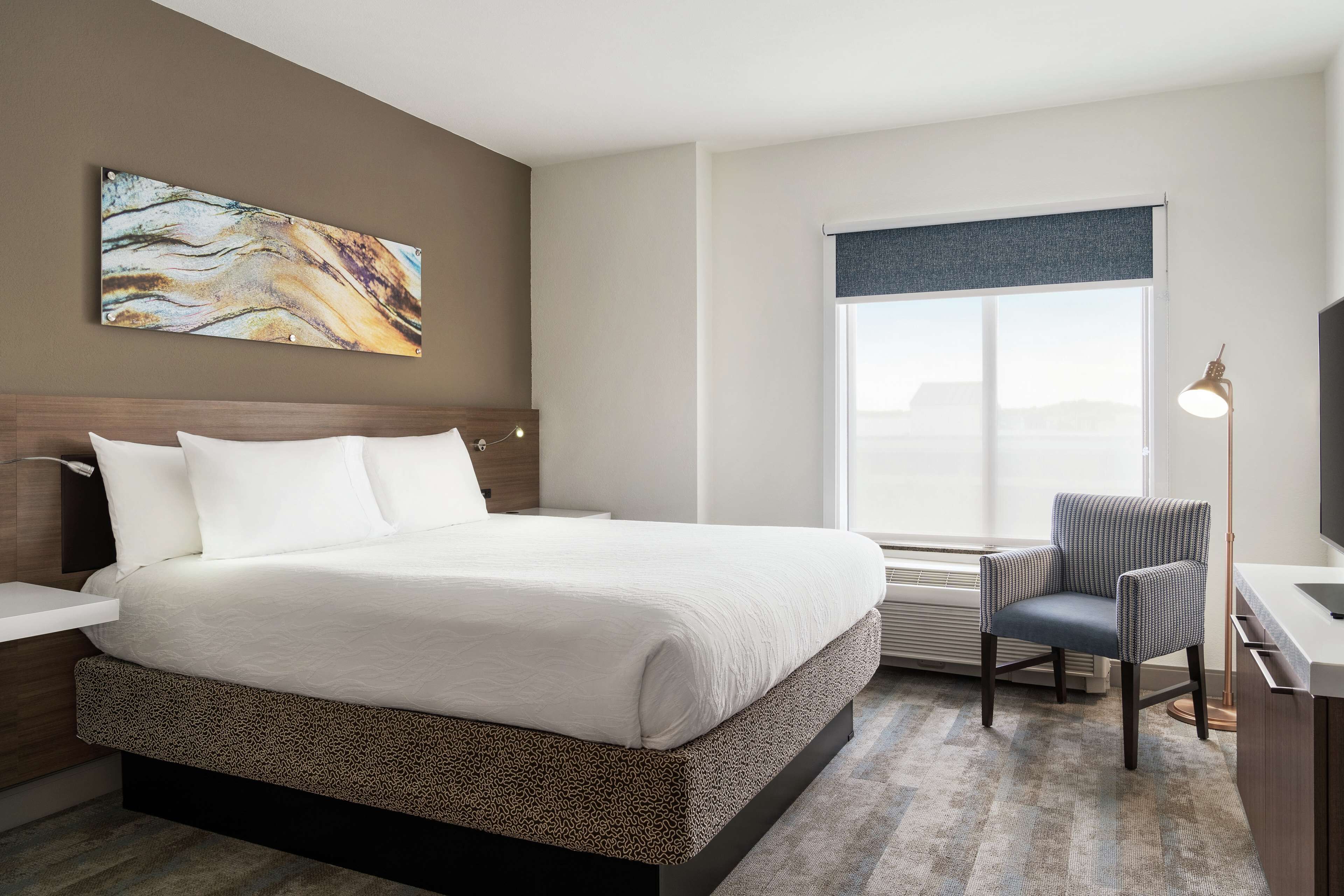 one bedroom suite, one king bed | in-room safe, desk, laptop workspace, iron/ironing board