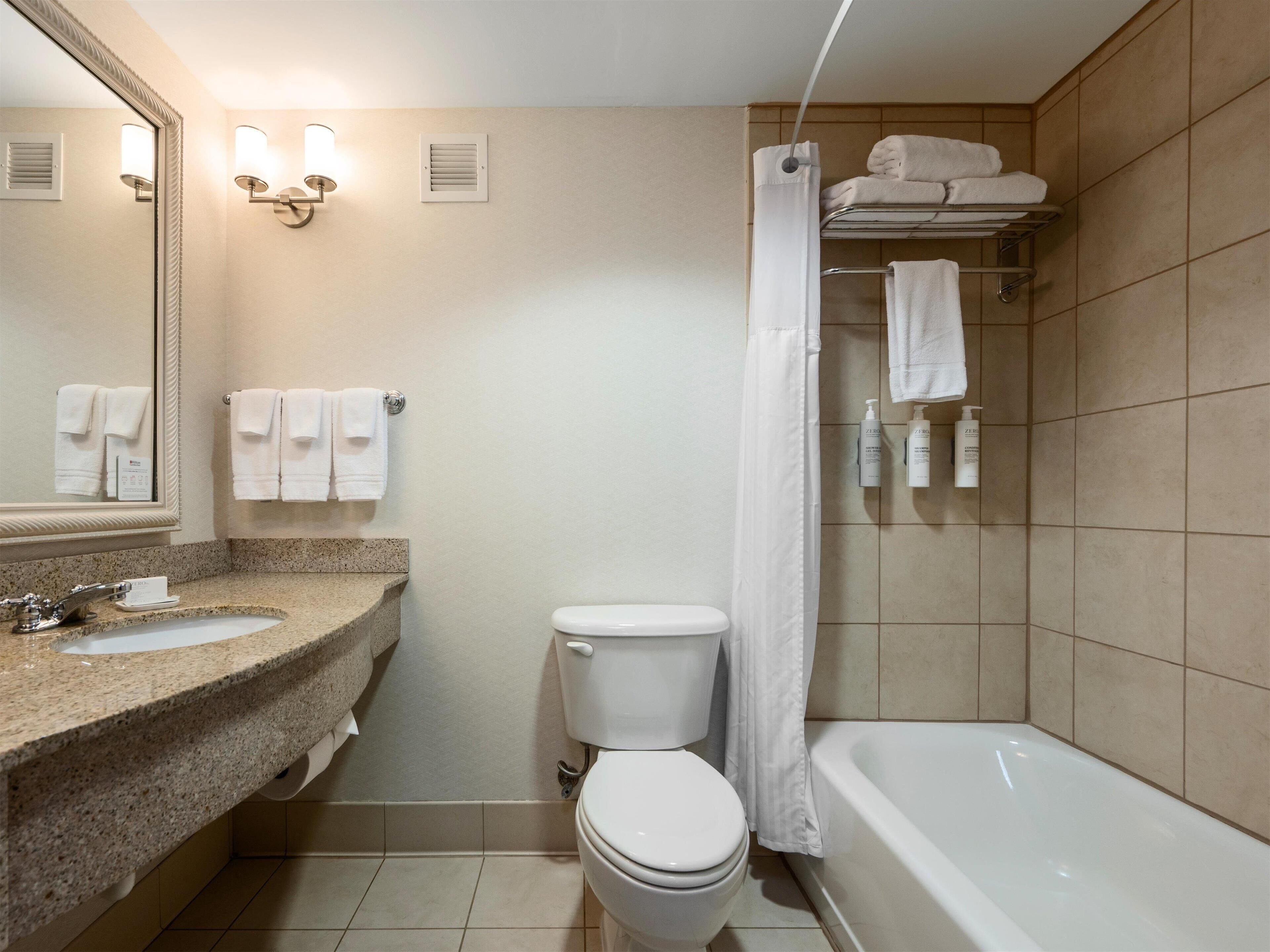 combined shower/bathtub, designer toiletries, hair dryer, towels