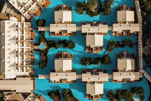 A resort with multiple overwater bungalows arranged around a central pool, connected by walkways. - Susesi Luxury Resort - All Inclusive (Serik)