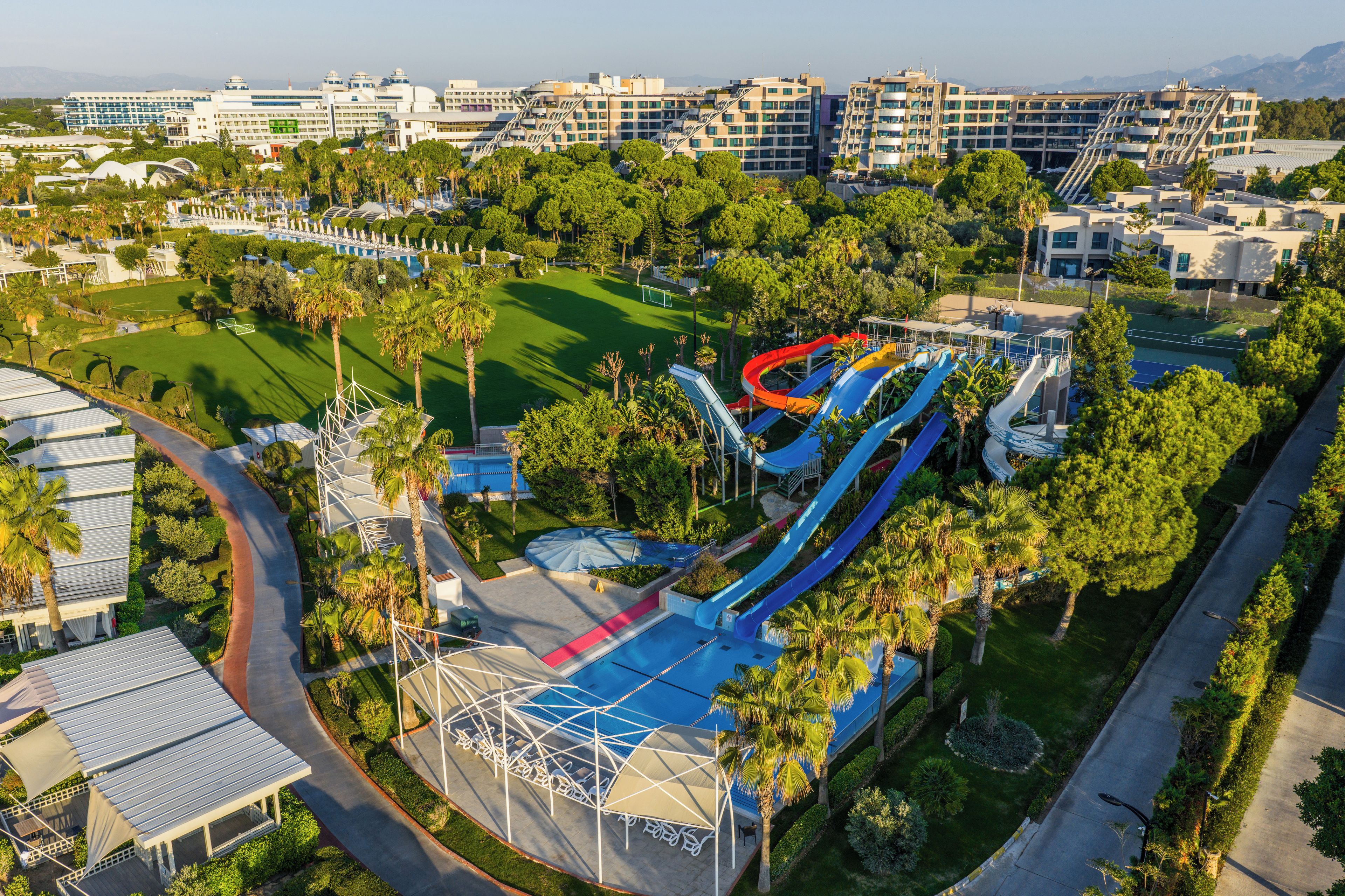A resort with multiple swimming pools, a water park, and a golf course.