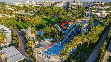 A resort with multiple swimming pools, a water park, and a golf course.