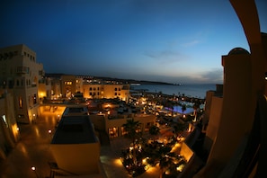 A resort with multiple buildings, outdoor seating areas, and a pool. - Grand Tala Bay Resort, Aqaba (Aqaba)
