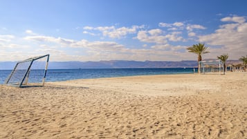 On the beach, sun loungers, beach umbrellas, beach towels
