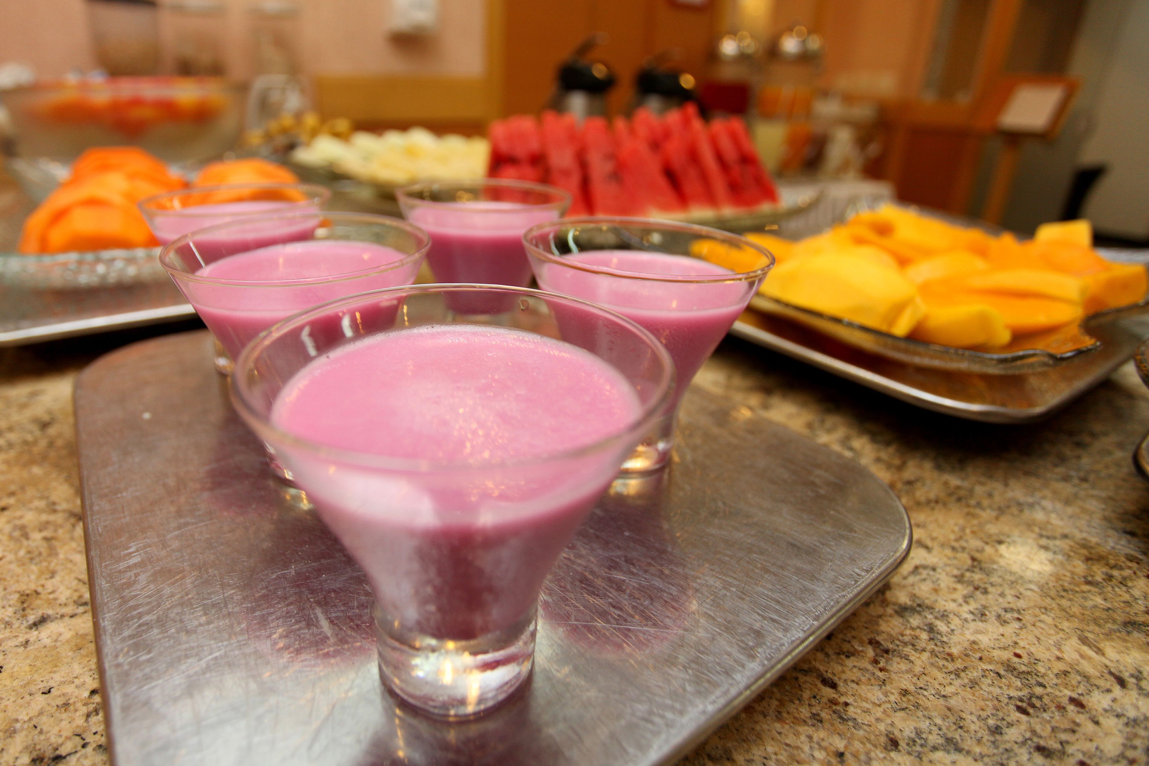 A buffet table with various food items and drinks.
