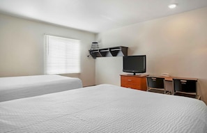 A hotel room with two beds, a desk with a computer, and a television. - Extended Stay America Select Suites - Phoenix - Peoria - Sun City (Peoria)