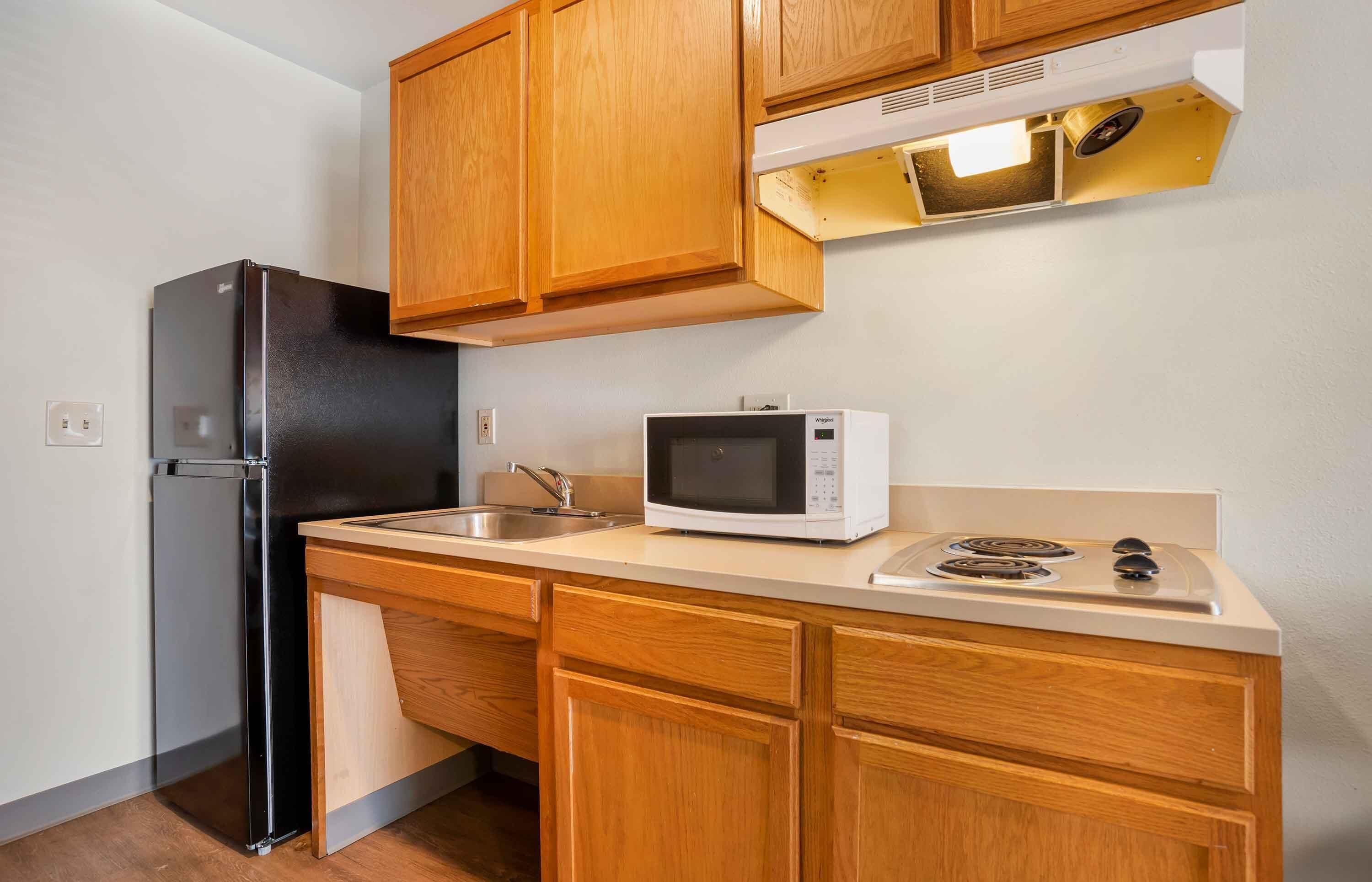 Full-size fridge, microwave, stovetop, cookware/dishes/utensils