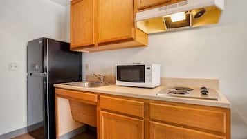 Full-size fridge, microwave, stovetop, cookware/dishes/utensils