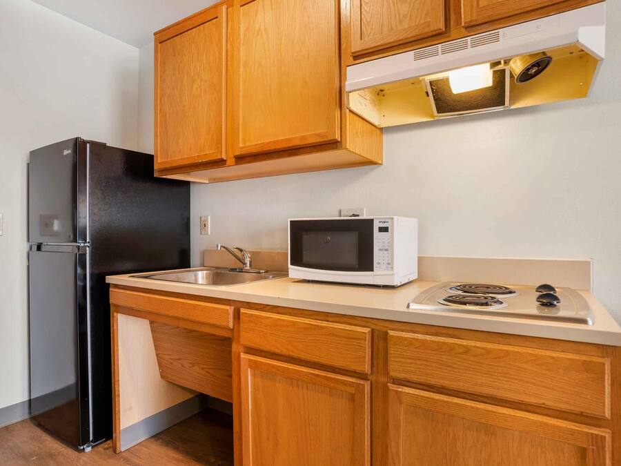 Full-size fridge, microwave, stovetop, cookware/dishes/utensils