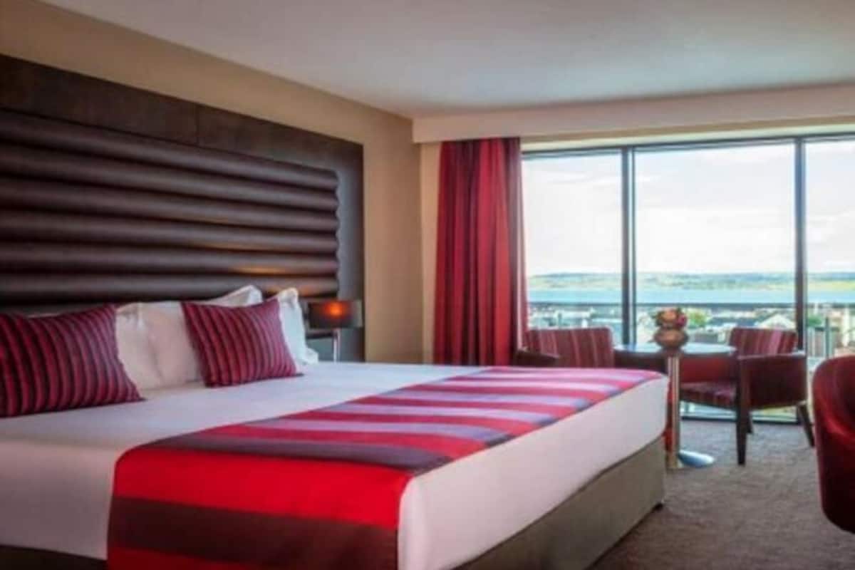 Hypo-allergenic bedding, desk, laptop workspace, blackout curtains