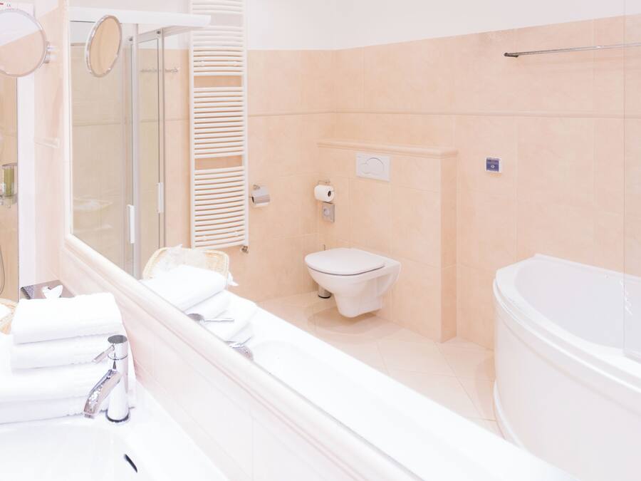A bathroom with a bathtub, toilet, and shower.