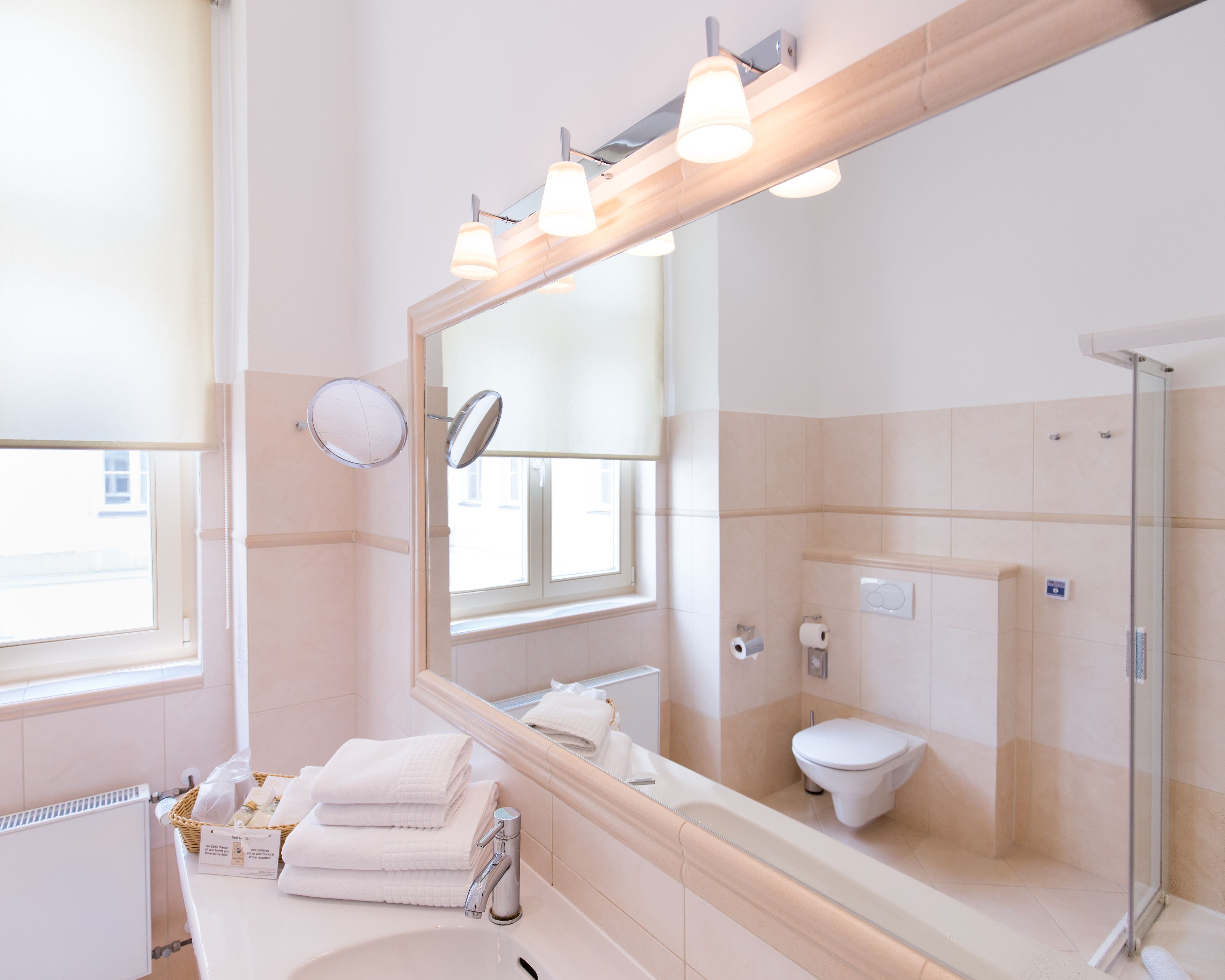 designer toiletries, hair dryer, towels, soap