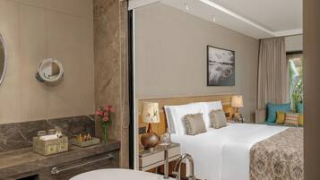 Deluxe Room, 1 King Bed | Bathroom | Combined shower/tub, rainfall showerhead, free toiletries, hair dryer