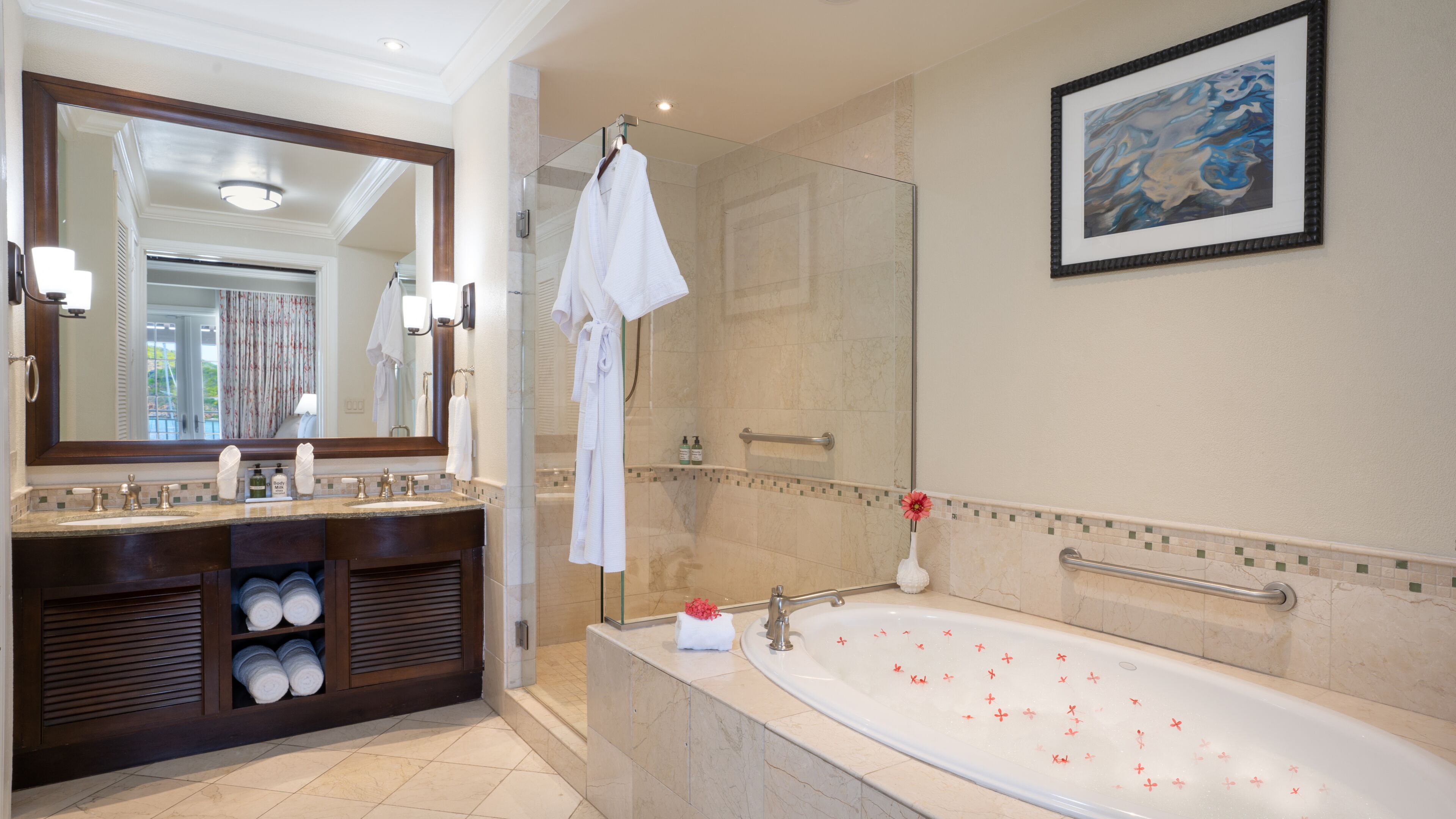 A modern bathroom with a large mirror, a bathtub, and a vanity with a sink and towel rack.