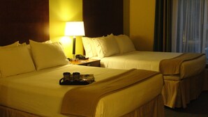 A hotel room with two beds, a nightstand with a lamp, and a tray with cups. - Holiday Inn Express & Suites Atlanta East – Lithonia by IHG (Lithonia)