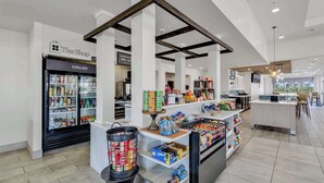 A modern retail area with a refrigerated section labeled 'CHILLED' and a counter displaying various products. - Hilton Garden Inn Myrtle Beach/Coastal Grand Mall (Myrtle Beach)