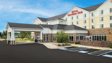 Experience the sleek, modern design of this hotel, featuring a covered entrance and ample parking with designated handicapped-accessible spaces.