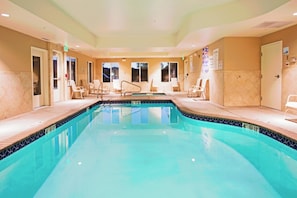 A swimming pool with lounge chairs and a tiled deck area. - Holiday Inn Express Reno Airport by IHG (Reno)