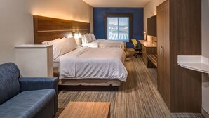 A hotel room with a bed, a desk, a chair, a wardrobe, and a window with a view. - Holiday Inn Express Reno Airport by IHG (Reno)