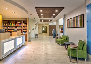 Relax in our lobby, featuring a reception desk, snack and beverage stations, and comfortable seating areas.