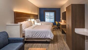 A hotel room with a large bed, a desk, a chair, a wardrobe, and a window with a view.