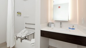 A modern bathroom with a shower, a sink, and a towel rack. - Holiday Inn Express & Suites Pueblo North by IHG (Pueblo)