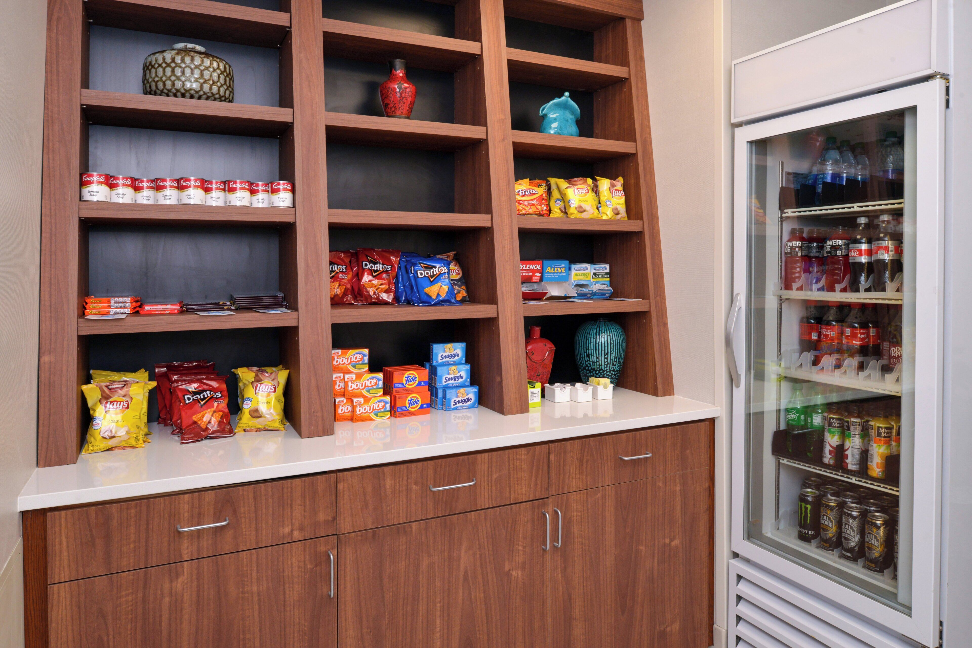 A snack and beverage display with various products including chips, soda, and energy drinks.