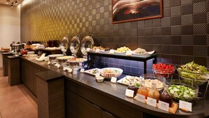A buffet with various food items and condiments.
