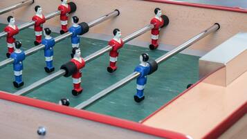 A foosball table with red and blue players.