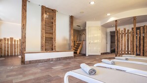 A spa room with wooden accents, a stone floor, and a staircase leading to a door. - Sporting Clubresidence (Primiero San Martino di Castrozza)