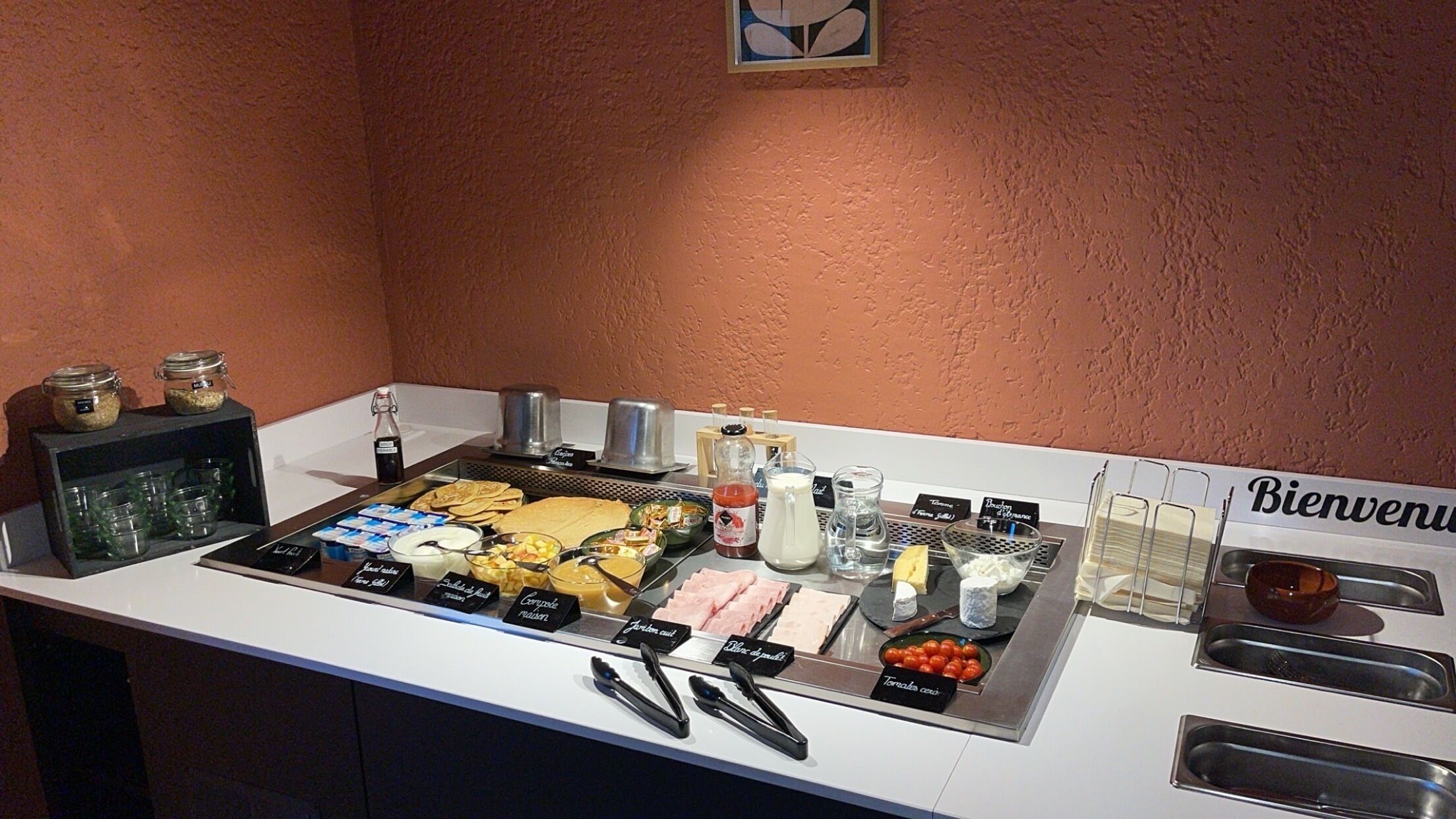 A breakfast buffet with various food items and condiments.