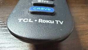 A remote control with buttons labeled 'Netflix,' 'Disney+,' 'Apple TV+,' 'CRAVE,' and 'TCL Roku TV.' - Kings Inn - Orillia (Orillia)