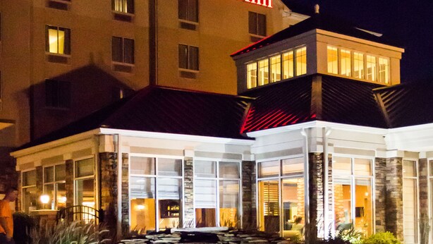 A hotel with a stone water feature in front, a well-lit entrance, and a sign reading "Hilton Garden Inn". - Hilton Garden Inn Clarksville (Clarksville)