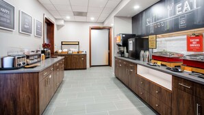 A modern kitchen with a breakfast bar, equipped with toasters, coffee makers, and a chalkboard menu. - Hampton Inn Elkins (Elkins)