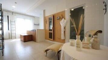 Relax in a serene bathroom with a large mirror, vanity, and seating area.