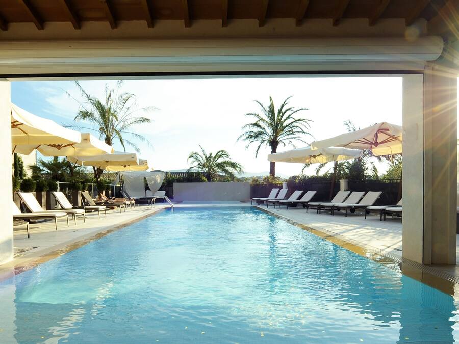 Seasonal outdoor pool, open 10:00 AM to 6:00 PM, pool umbrellas