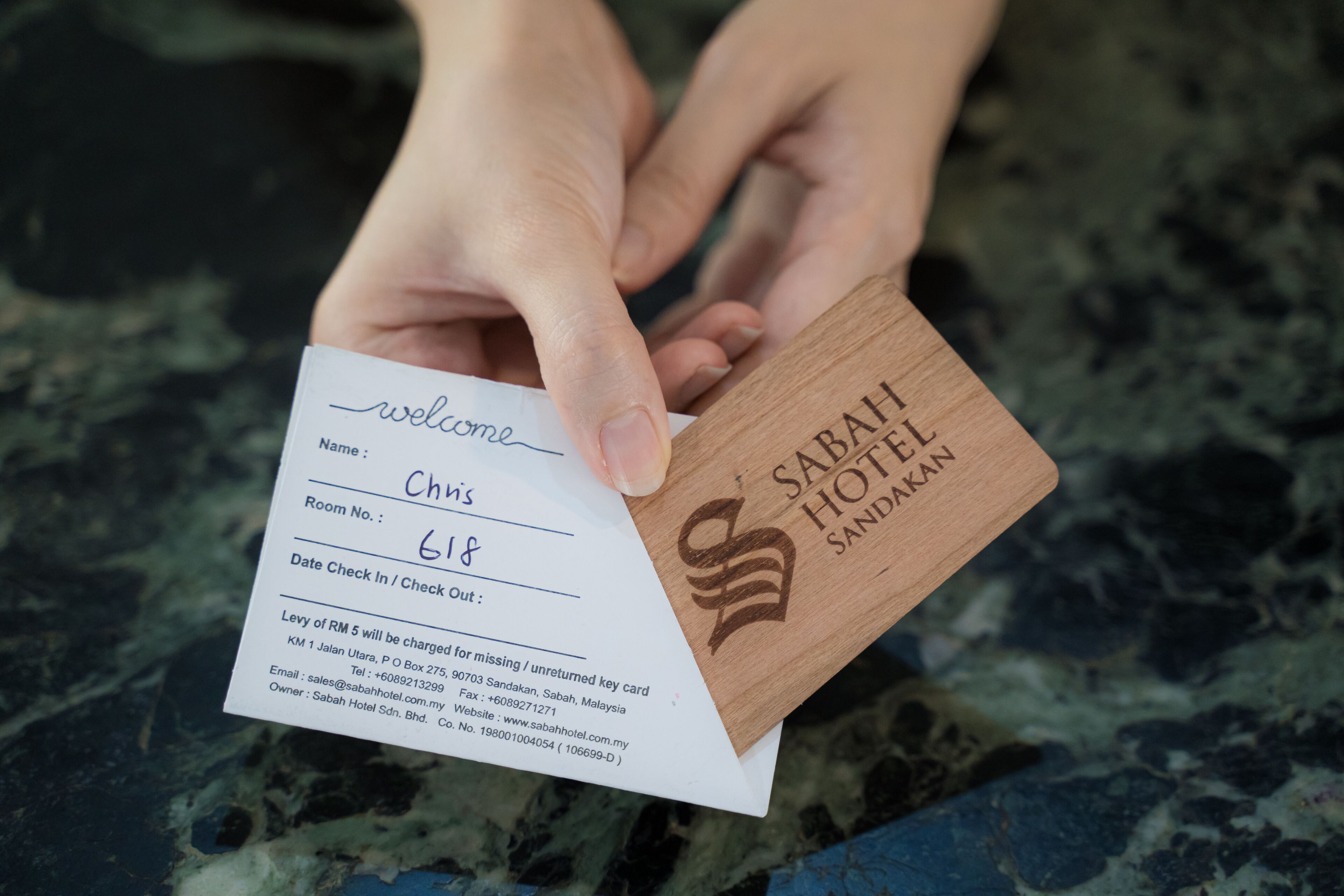 A welcome card with a room number and hotel name.