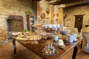 A buffet table with various food items and condiments.