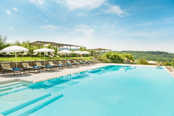 Outdoor pool, an infinity pool, pool loungers