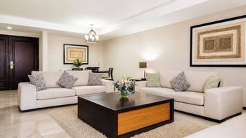 A modern living room with two sofas, a coffee table, and a dining area.