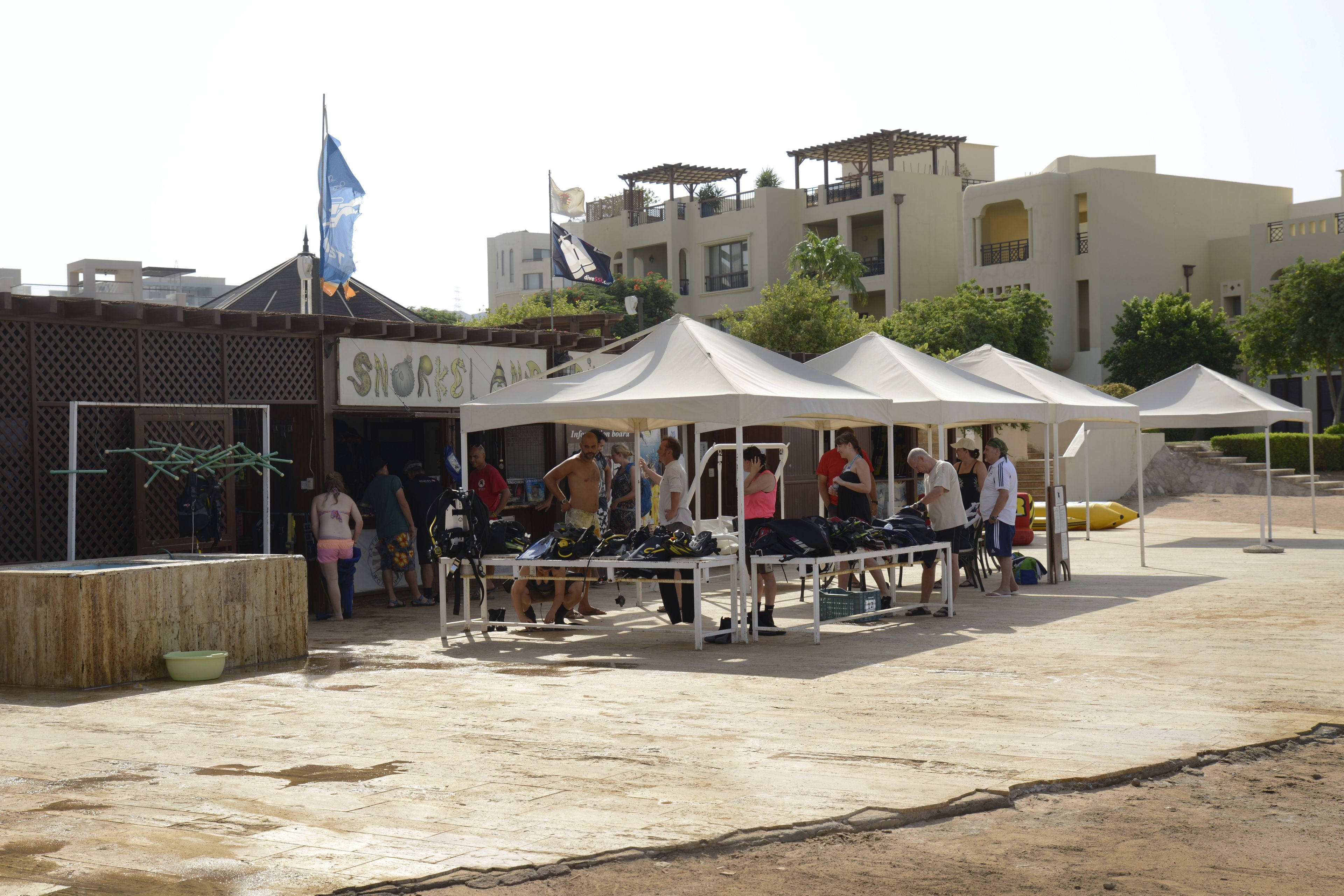 Ein Markt am Strand mit Zelten und Menschen.