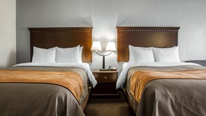 A hotel room with two beds, a nightstand with lamps, and a carpeted floor. - Comfort Inn & Suites Lumberton Central I-95 (Lumberton)