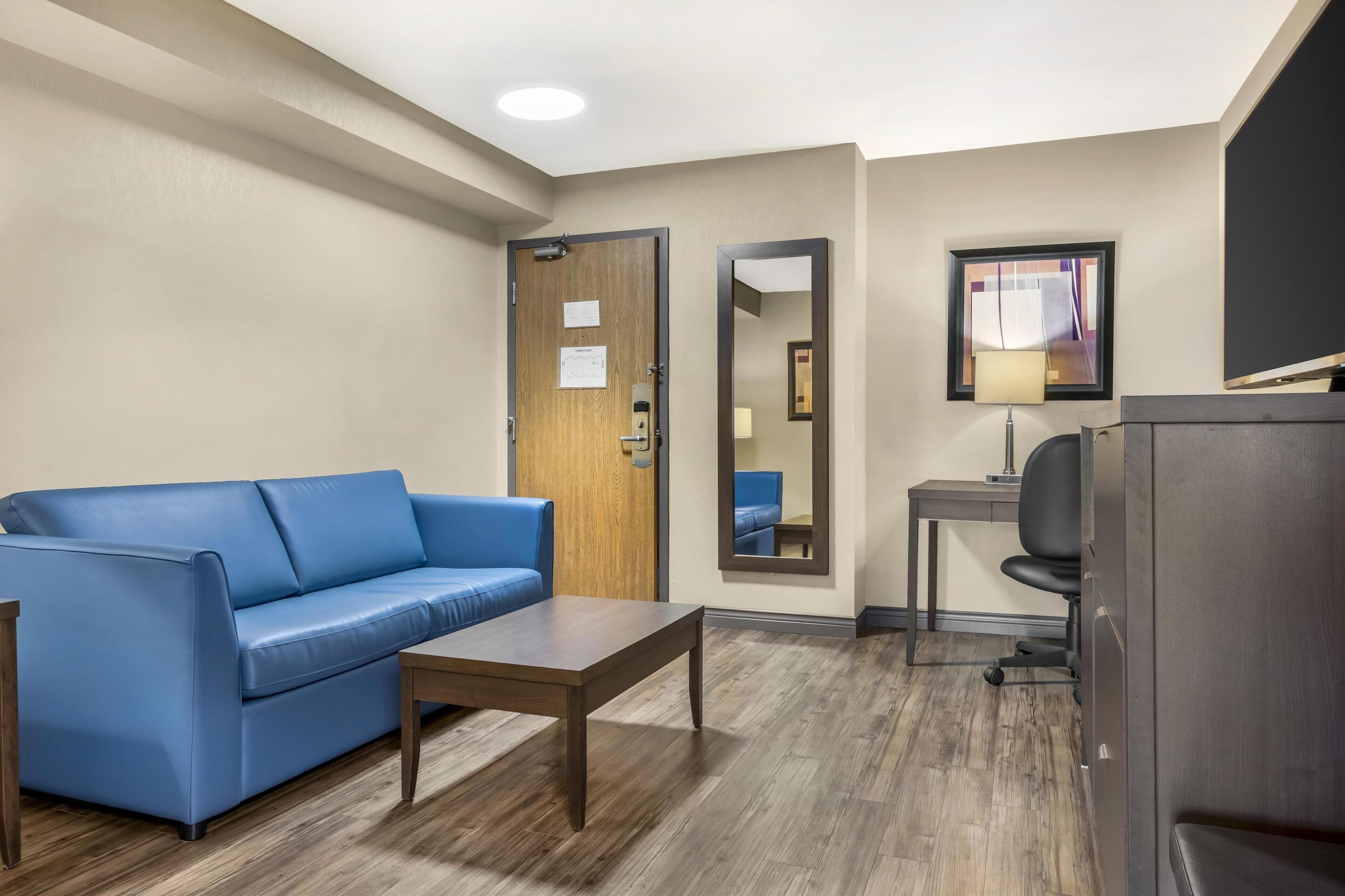 suite, 1 king bed, non smoking (larger room;with sofabed) | desk, laptop workspace, blackout curtains, iron/ironing board