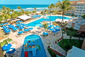 A resort pool area with multiple swimming pools, sun loungers, and umbrellas. - Gran Hotel Stella Maris Urban Resort & Conventions (Salvador)